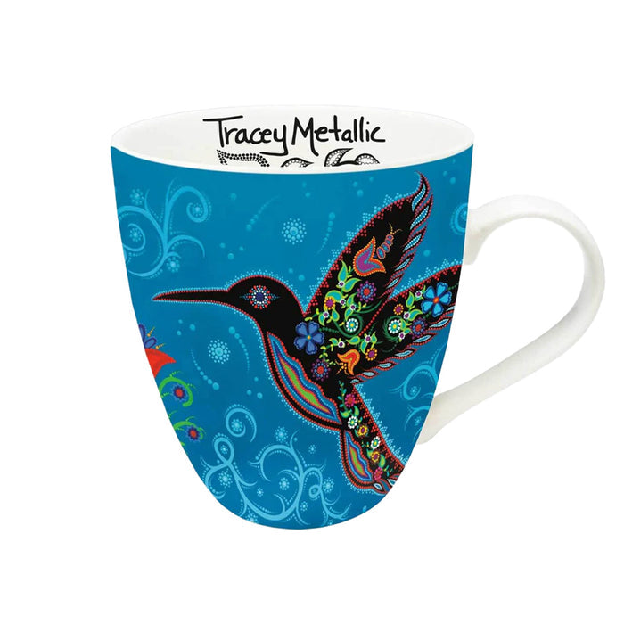 Mug with colorful bird design on a blue background, featuring Tracey Metallics branding.