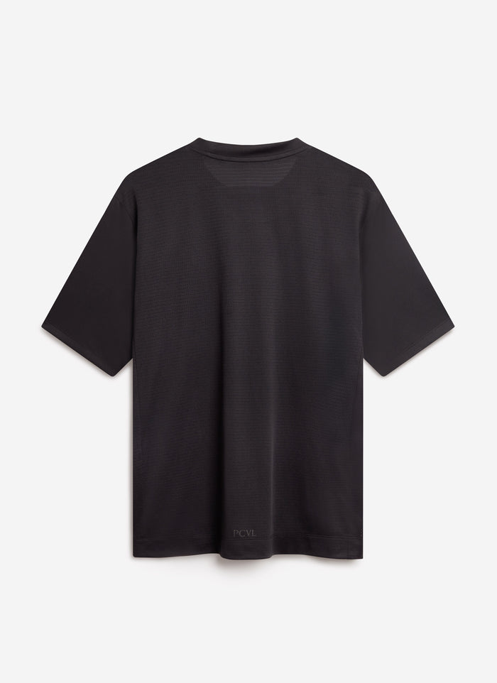 The back of the Percival PCVL Performance Top in black, showing the ventilated mesh fabric and subtle branding on the hem.