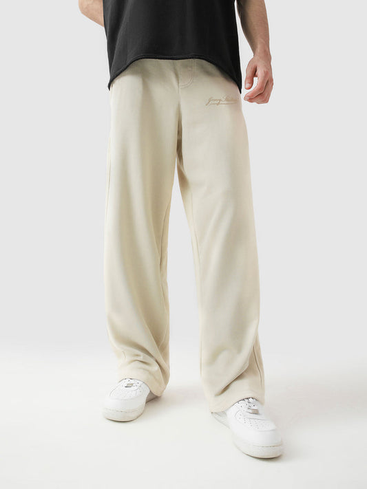 Cream baggy trousers front view male model relaxed fit streetwear Pakistan – GROOVY