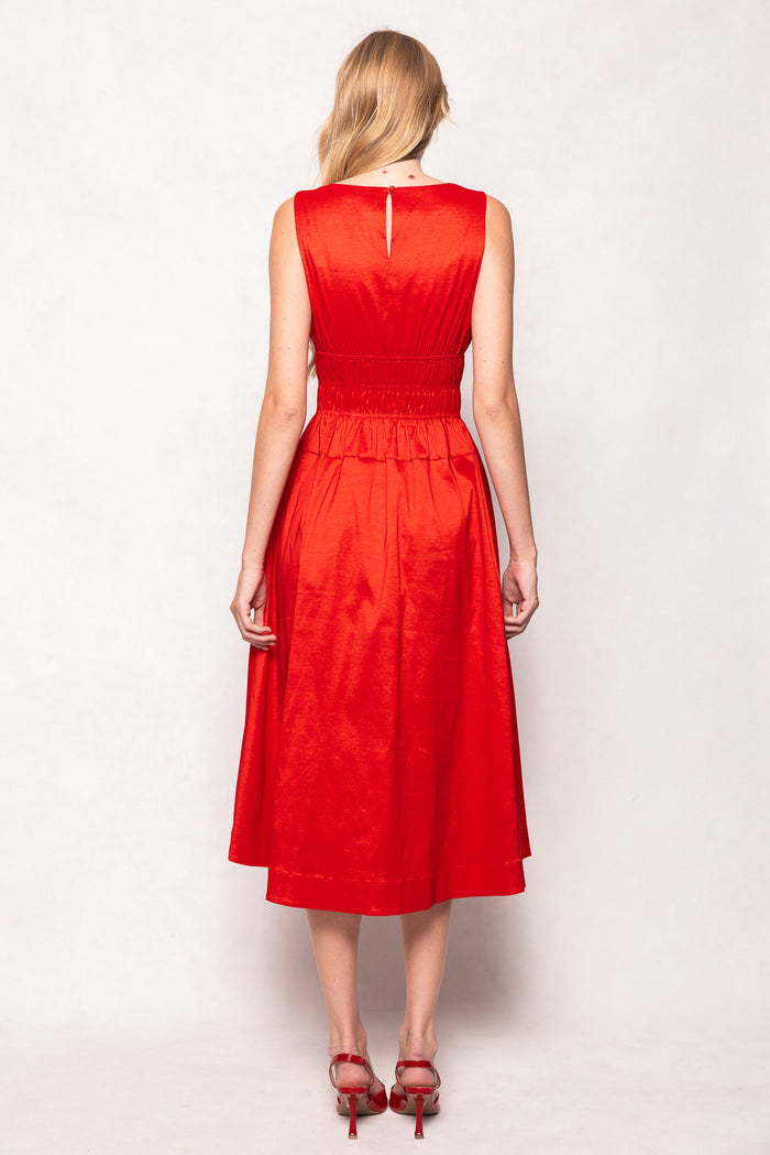 Woman wearing a red dress against a white background