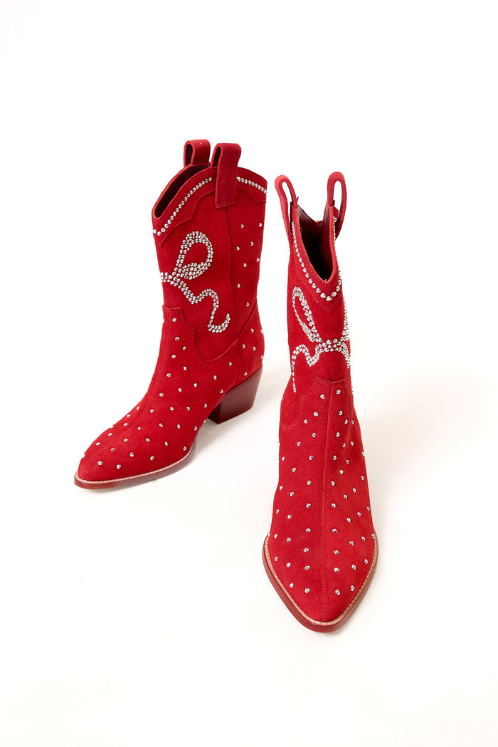 The Channing Bootie in Red by Ivy City Co features suede, bootie-style cowboy boots adorned with silver studs and rhinestone detailing, shown on a white background.