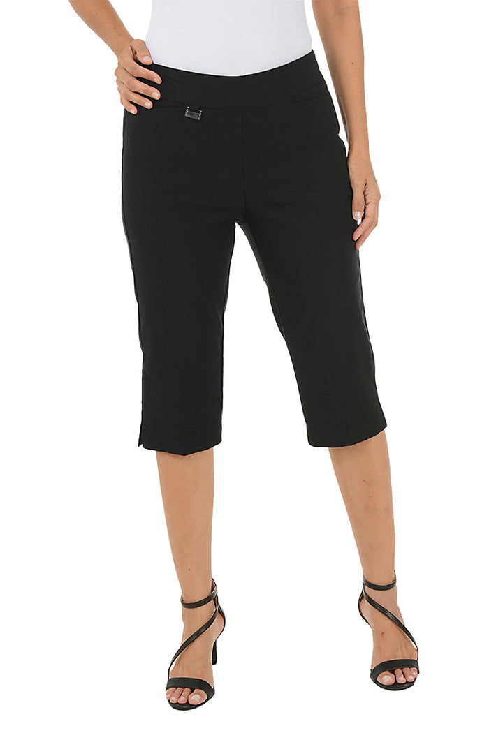 Black capri pants worn by a person on a white background.