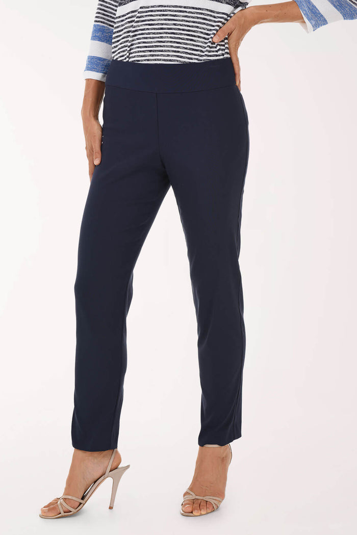 Navy pants worn by a person on a white background