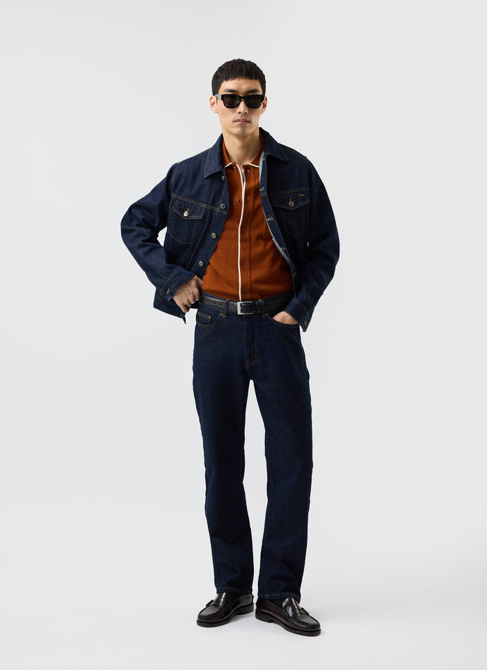 A man models the Percival rust wool-blend Contrast Trim Shirt, styled with a dark denim jacket and jeans.
