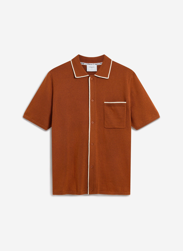 The Percival Contrast Trim Shirt in rust wool, laid flat against a plain background, showing its white contrast trim.