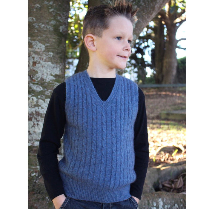 Boy facing right wearing light blue colour vest.