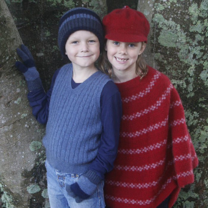 Boy wearing light blue colour vest & standing next to girl wearing red clothes.