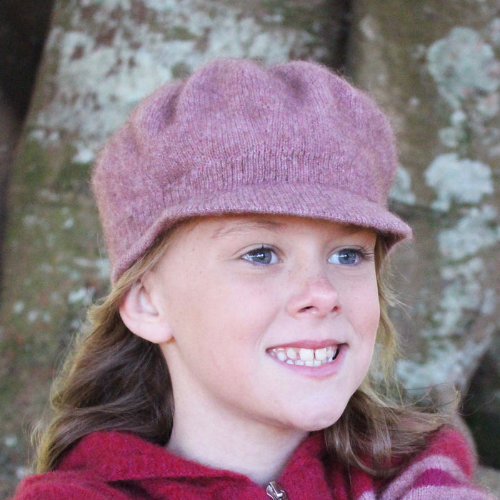 Girl smiling wearing pink Gatsby hat.