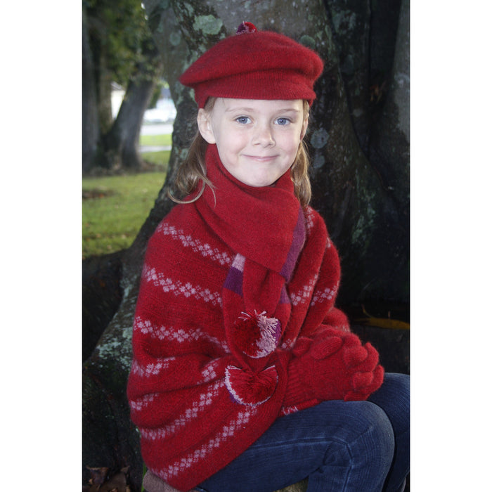 Girl sitting wearing red Gatsby hat.