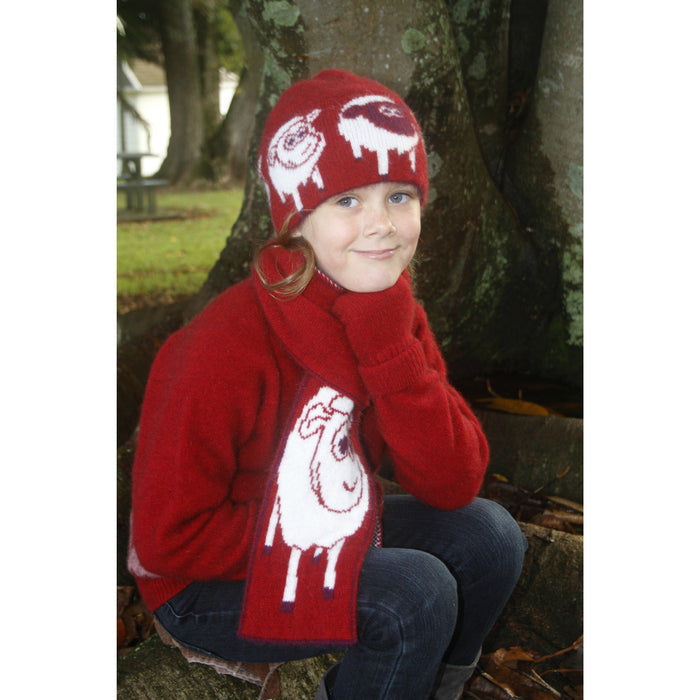 Girl sitting to the side wearing scarf in colour red.