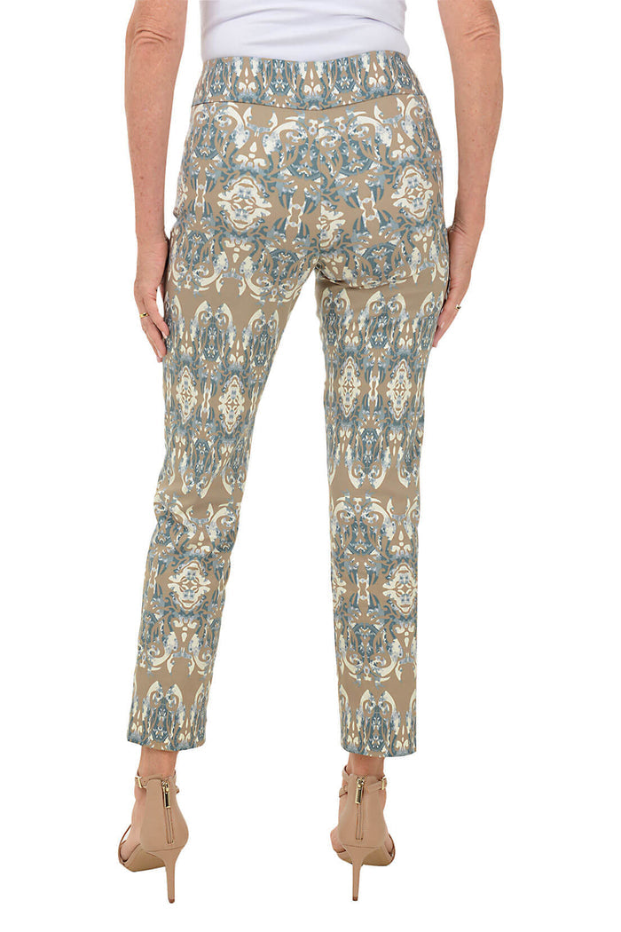A back shot of a model wearing a pair of pull-on ankle pants with an elasticized waistband and a damask mosaic print.