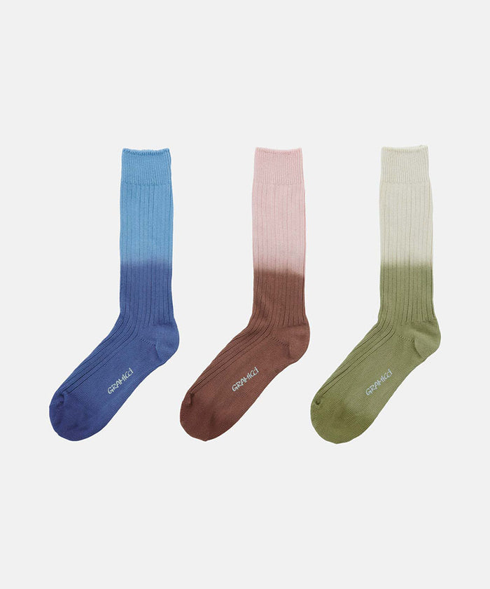 Three pairs of Gramicci Dip Dye Socks 
in blue, rosewood, and cactus against a light-tone background.