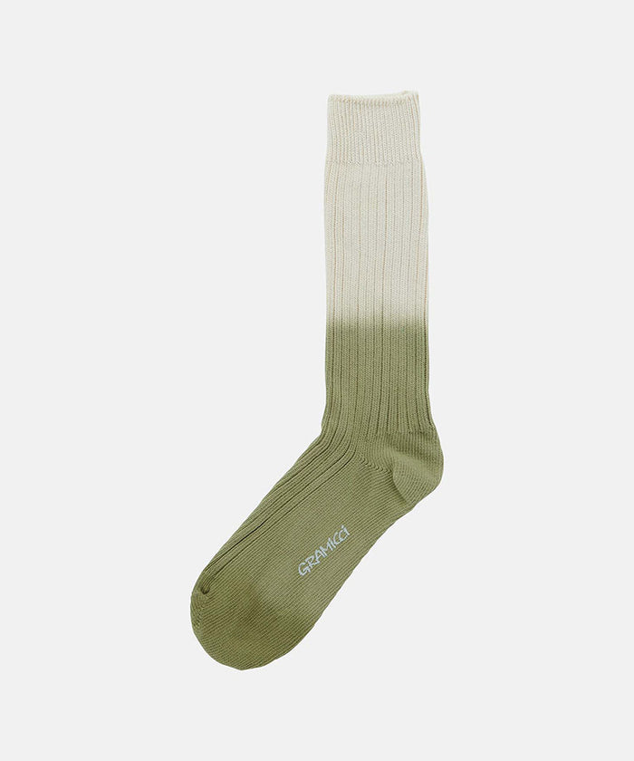 Cactus colored Gramicci Dip Dye Socks against a light-tone background.