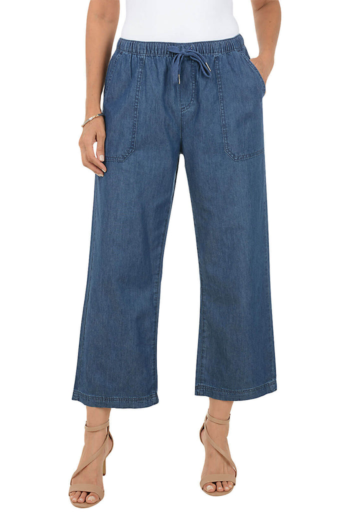 Blue denim pants worn by a person on a white background