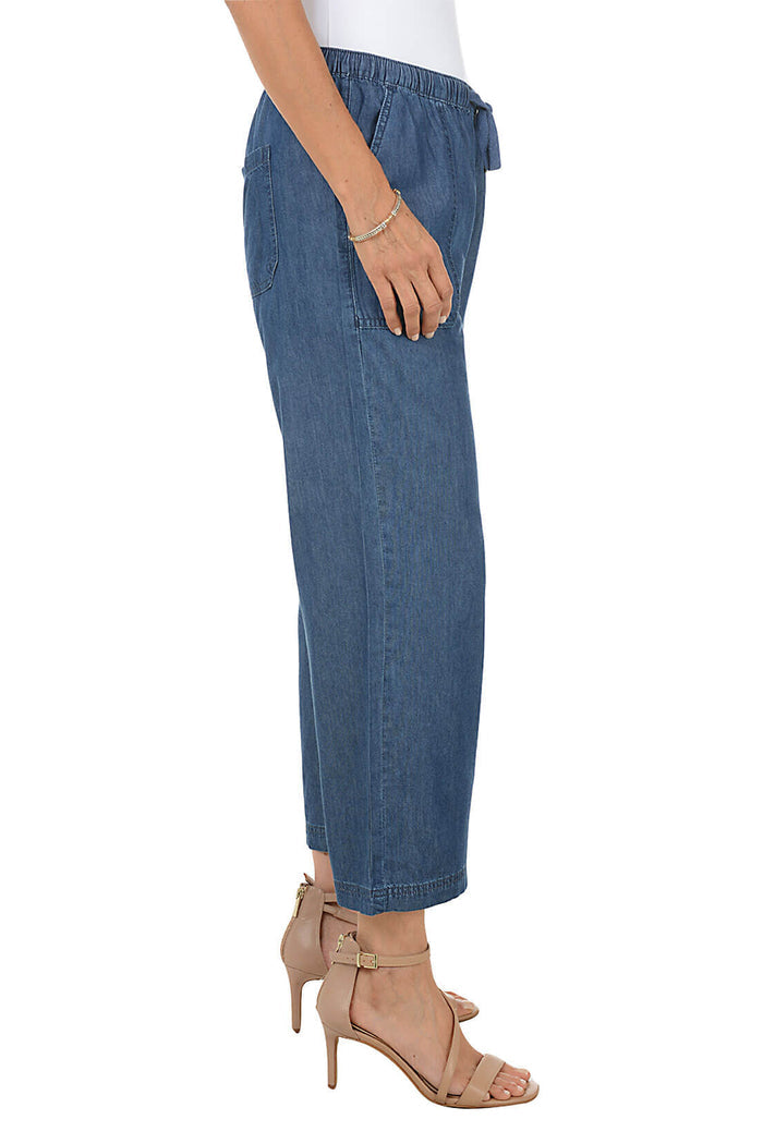Blue jeans worn by a person on a white background