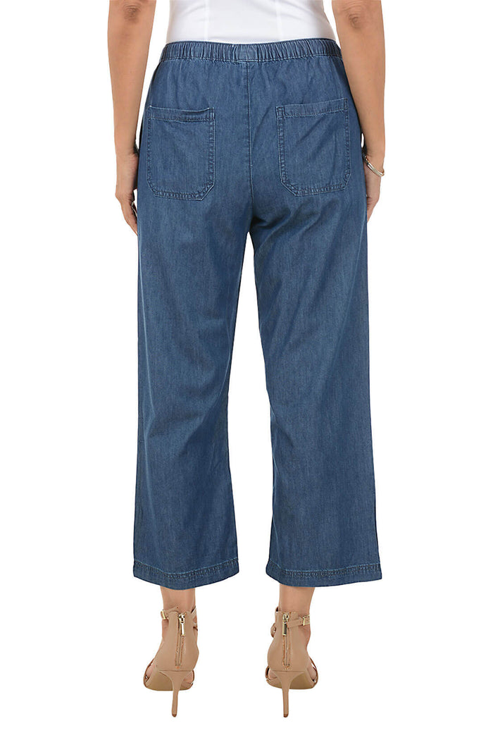 Blue denim pants worn by a person on a white background