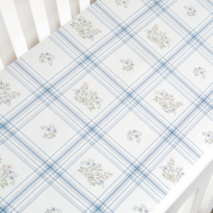 Floral patterned fabric with blue and white checkered design on a white background