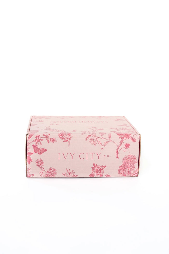A light pink rectangular Gift Box featuring floral and butterfly designs with Ivy City Co printed on the front, displayed against a plain white background.