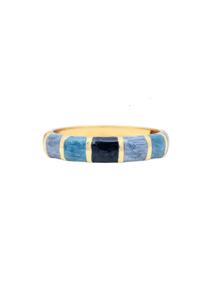 Gold framed bangle bracelet with blue enamel squares on a white background