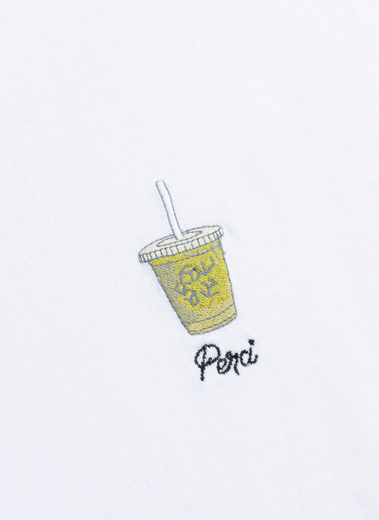 A close-up of the iced matcha latte embroidery on the white organic cotton oversized t-shirt from Percival.