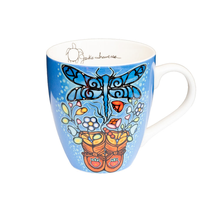 Mug with a dragonfly and floral design on a blue background