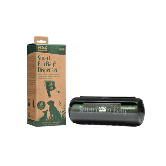 White background with MDC Smart Eco bag dispenser in green and brown cardboard packaging. On the packaging is text 'Smart Eco Bag Dispenser'. Next to the box is the black bag dispenser.