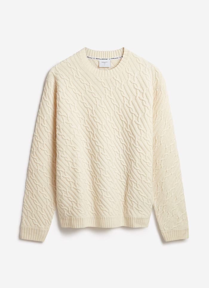 The Percival Melville Cable Knit Jumper in ecru, a wool-blend knit with a diagonal pattern, laid flat on a white background.