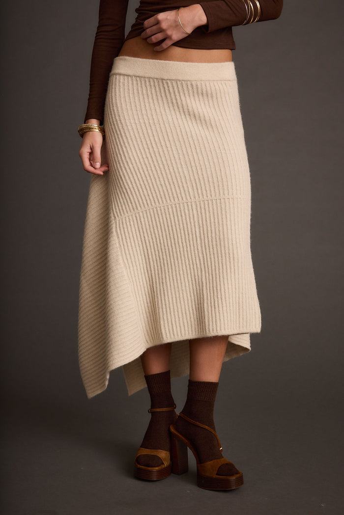 Detail shot of the Mod Cream Asymmetrical Skirt highlighting the design elements.