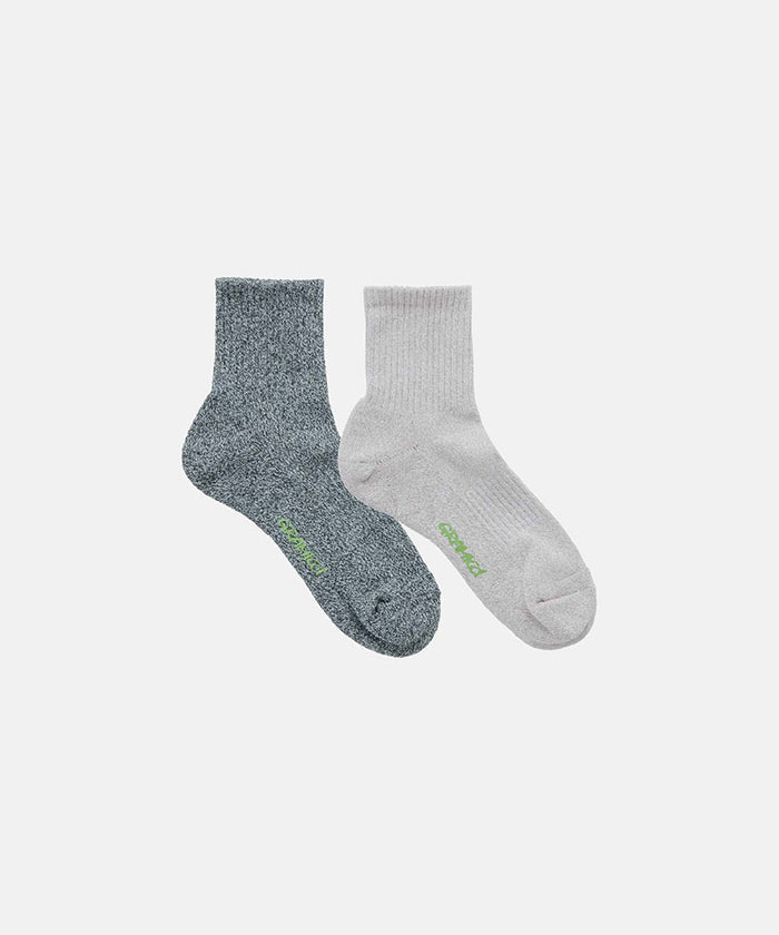 Jet grey and camel grey Gramicci Paper Mix Sock against a light-tone background.
