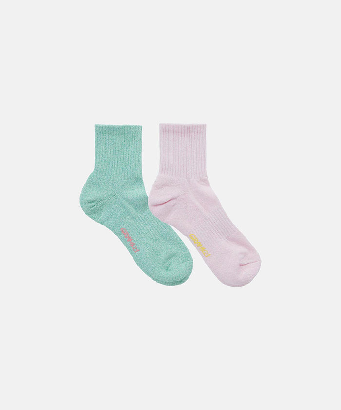 Crimson and emerald Gramicci Paper Mix Socks against a light-tone background.