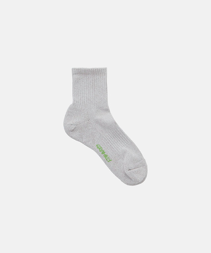 Camel grey Gramicci Paper Mix Sock against a light-tone background.