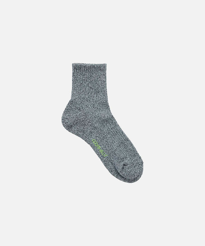 Jet grey Gramicci Paper Mix Sock against a light-tone background.