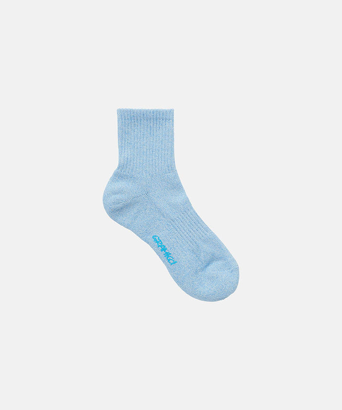 Sky blue Gramicci Paper Mix Socks against a light-tone background.
