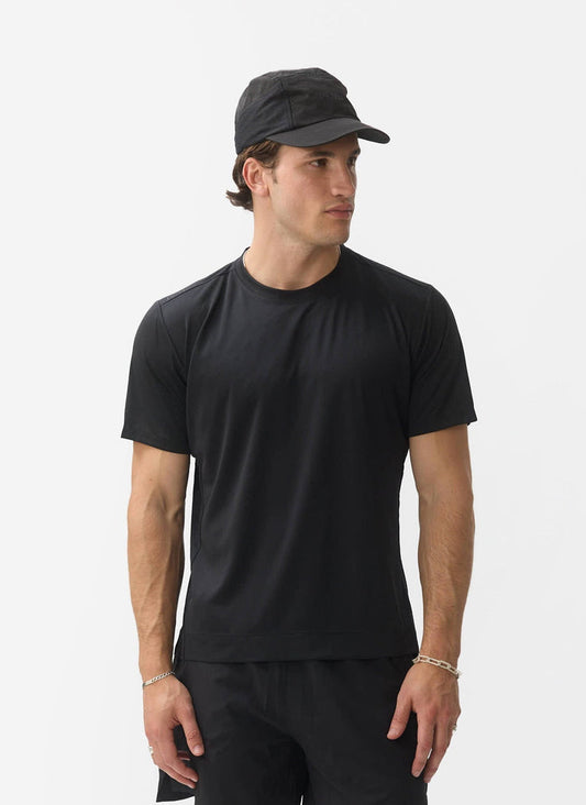 Percival PCVL performance top in black, a recycled moisture-wicking training tee worn by a model with a black cap.