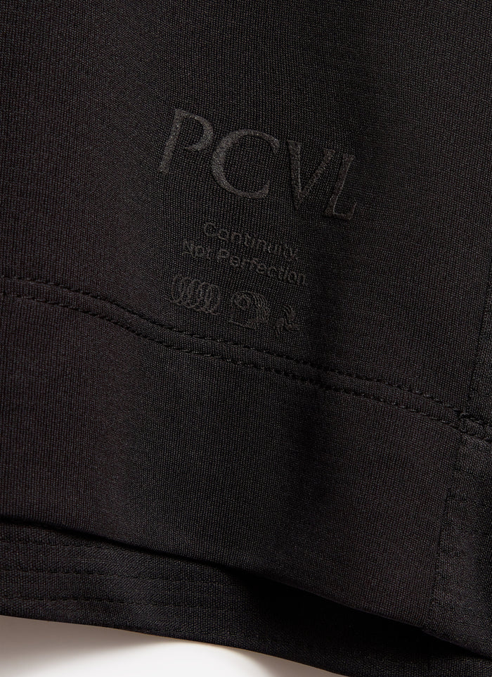 Close-up of the black Percival PCVL Performance T-shirt, showing its tonal branding and slogan 'Continuity, Not Perfection'.