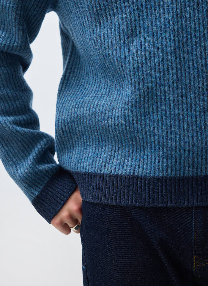 A close-up of the Percival Picnic Polo in navy, showing the detail of the two-toned blue vertical ribbed wool knit.