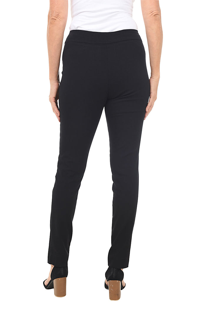 A back shot of a model wearing black pull-on slim full-length pants with a slim leg, paired with a white top and black shoes.