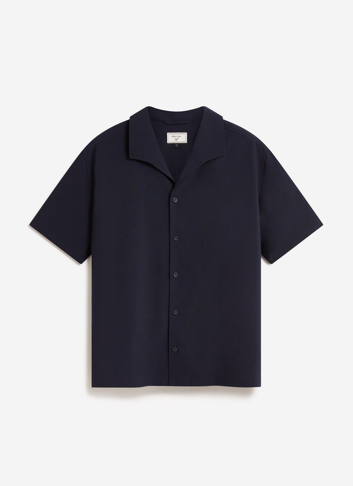 The Percival x Warren Relaxed Cuban Drape Shirt in navy blue, a short-sleeve style laid flat against a white background.