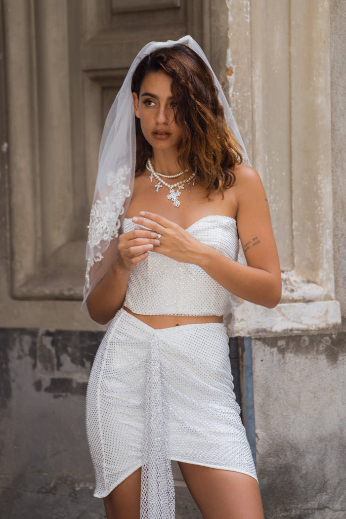 Full-length view of the mini skirt showing the drape and movement.