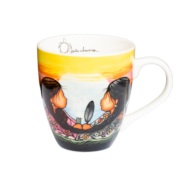 Mug with artistic design of two people and a sunset, on a white background