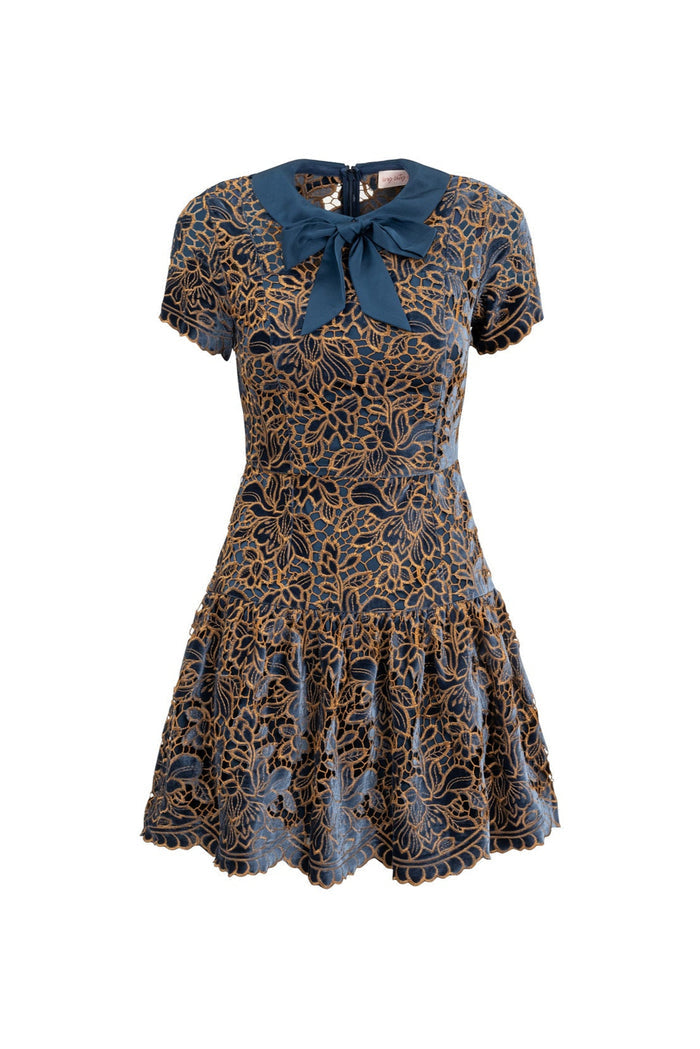 Patterned dress with a blue bow on a white background