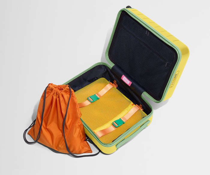 The Kids Carry-On suitcase in Sunshine Yellow shown open and empty on its side to show capacity, and an orange laundry bag can double as a backpack for smaller travelers.
// 
Includes a drawstring laundry bag  that doubles as a backpack for smaller travelers.