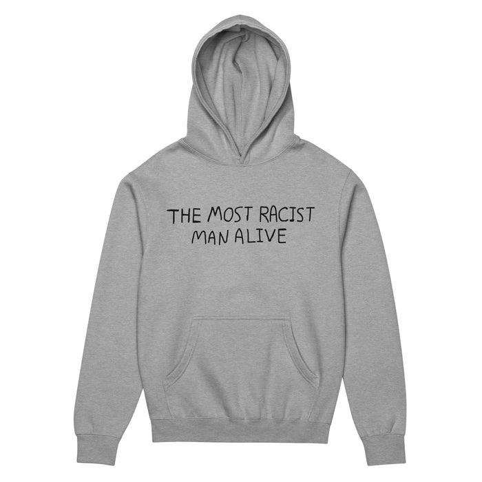 The Most Racist Man Alive Hoodie - The all-caps phrase "THE MOST RACIST MAN ALIVE" in a casual, handwritten-style black (#000000) font on an optic white (#FFFFFF) background. The dissonance between the extreme statement and the informal typography creates the ironic effect.