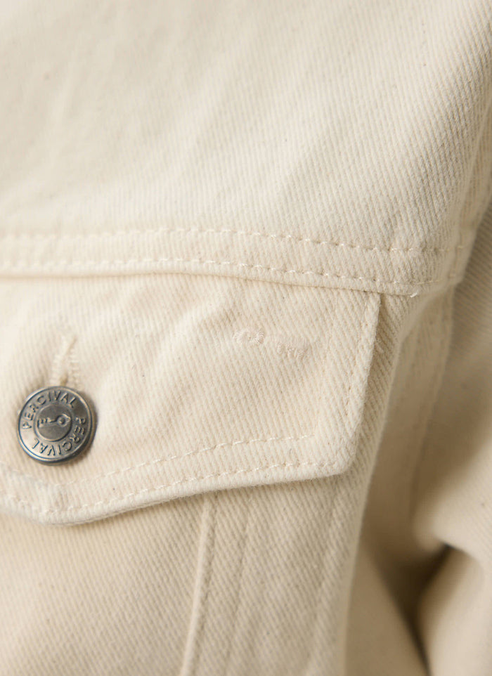 A detailed close-up of the ecru denim, chest pocket stitching, and branded shank button on Percival Western Trucker Jacket.